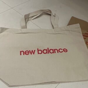 New Balance Beige Tote with Red Logo. Comes with a paper bag.